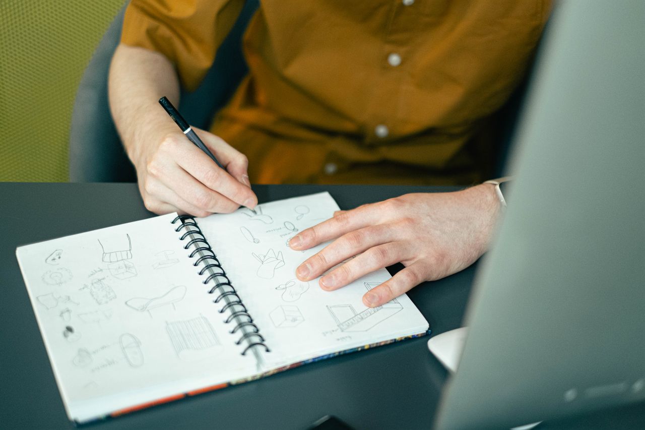 Creative team sketching and designing on whiteboards